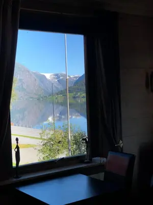 a window with a view of a lake and mountains at Jølster Lake View in Årdal