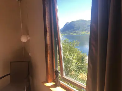 a window with a view of a body of water at Jølster Lake View in Årdal