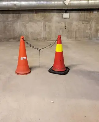 two orange and yellow traffic cones chained to a chain at Ski in Ski out Trysil in the mountain of Norway 60m from the Slopes in Trysil