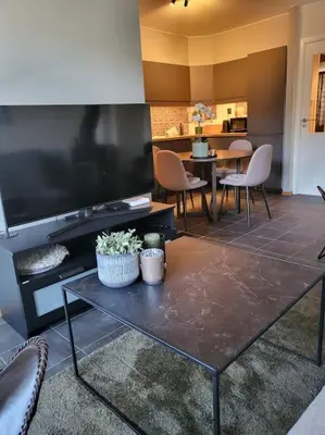 a living room with a table and a large television at Ski in Ski out Trysil in the mountain of Norway 60m from the Slopes in Trysil