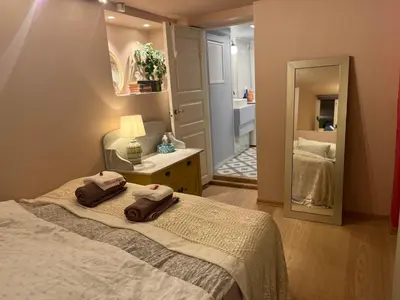 a bedroom with a bed with two towels on it at New beautiful flat, parking! in Bergen