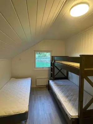 a room with two bunk beds and a window at New appartment in Lom inkl bedding in Lom