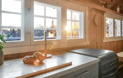 a kitchen with windows and a counter with a stove at 3 Bedroom Amazing Home In Gol in Gol