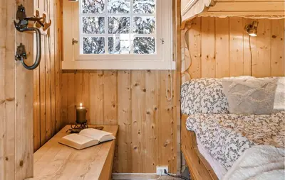 a bedroom with a bed and a window and a candle at 3 Bedroom Amazing Home In Gol in Gol