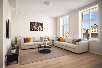 a living room with two couches and a table at Allmenningen Apartments in Bergen