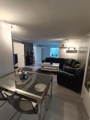 a living room with a couch and a table at 3-roms leilighet, innsjekk uten vert. Egen inngang in Ålesund