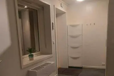 a room with a window and a white refrigerator at 3-roms leilighet, innsjekk uten vert. Egen inngang in Ålesund