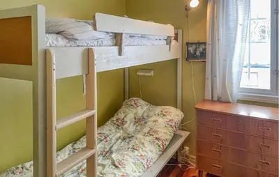 a bedroom with two bunk beds and a dresser at Gorgeous Home In Os I Østerdalen in Os
