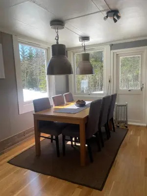 a dining room with a wooden table and chairs at Hus nær lillehammer og sjusjøen in Lillehammer