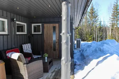 a house with a pile of snow on the porch at Hus nær lillehammer og sjusjøen in Lillehammer