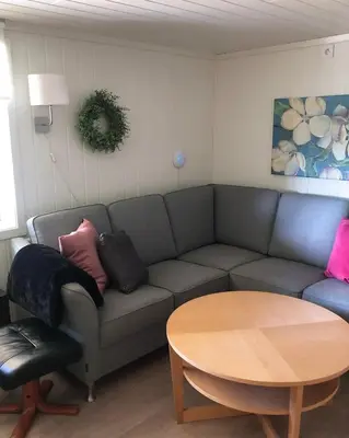 a living room with a couch and a table at Store Ringheim Apartment - Villa Solberg in Vossevangen