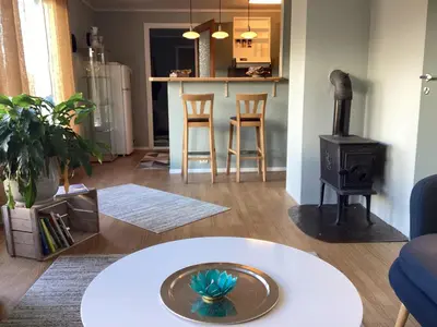 a living room with a table and a stove at Fjordview 35 in Lofthus