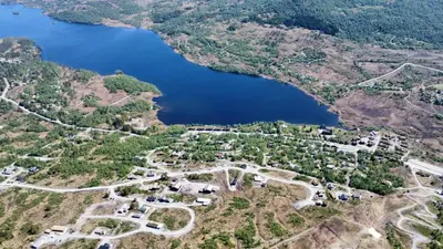 an aerial view of a lake and a forest at Ladebua in Brunstad