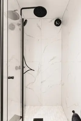a shower with a glass door in a bathroom at Bryggen // Fløyen Living in Bergen