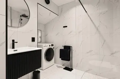 a bathroom with a washing machine and a sink at Bryggen // Fløyen Living in Bergen