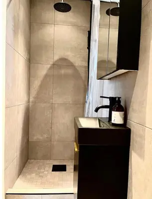 a small bathroom with a sink and a shower at Byleilighet nær Fløyen in Bergen
