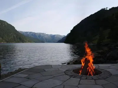 a fire pit next to a body of water at 