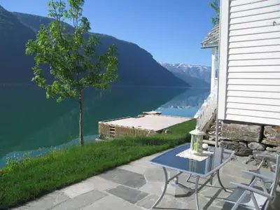 a table and chairs on a patio with a view of a lake at 