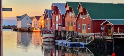 a group of colorful buildings next to the water at Rorbu i Bud Havn in Bud