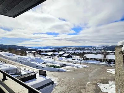 a parking lot with snow on the ground at Riddertunets lune leilighet - dyr tillatt in Beitostøl