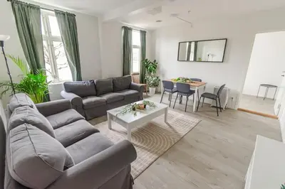 a living room with a couch and a table at 7 Soverom i hjertet av Bergen in Bergen
