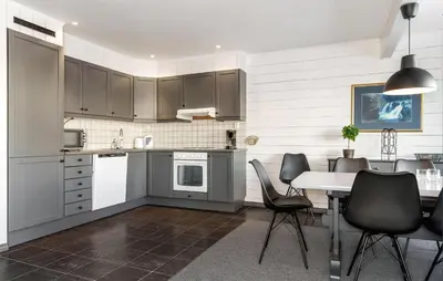 a kitchen with gray cabinets and a table and chairs at Lovely Apartment In Hemsedal With Sauna in Hemsedal