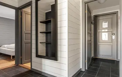 a hallway of a home with a wall with shelves at Lovely Apartment In Hemsedal With Sauna in Hemsedal