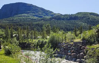 a creek in a field with a mountain in the background at 2 Bedroom Cozy Apartment In Hemsedal in Hemsedal