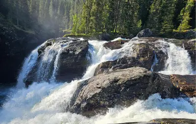 a waterfall on the side of a river with rocks at 2 Bedroom Cozy Apartment In Hemsedal in Hemsedal