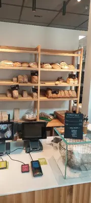 a bakery counter with shelves of pastries and a display at Bergen city apartment in Bergen