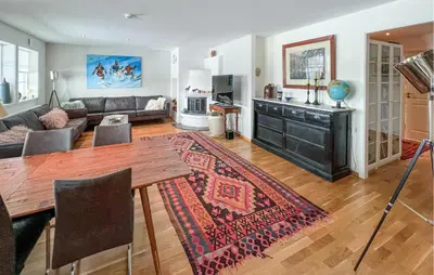 a living room with a table and a couch at 3 Bedroom Cozy Apartment In Gålå in Frya