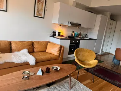 a living room with a couch and a table at Seagull Holiday& Businnes Apartment in Trondheim