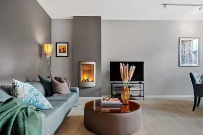a living room with a couch and a table at Modern Apartment In The Heart of Bergen in Bergen