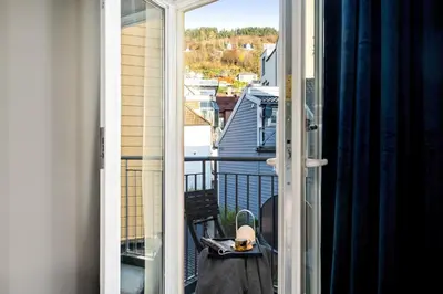 an open door to a balcony with a view at Modern Apartment In The Heart of Bergen in Bergen