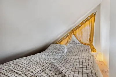 a bed in a room with a window at Moderne og sentral leilighet på Geilo in Geilo