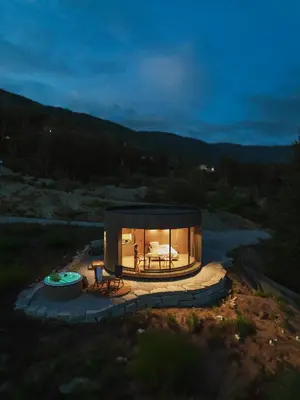 a round house with a fireplace in the middle at Sogndal Fjordpanorama- The Panorama View in Kaupanger