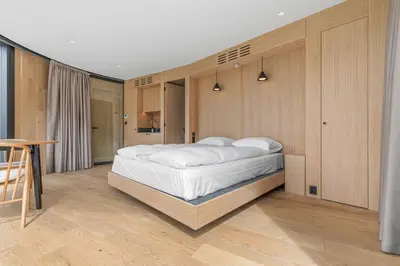 a bedroom with a large white bed in it at Sogndal Fjordpanorama- The Panorama View in Kaupanger