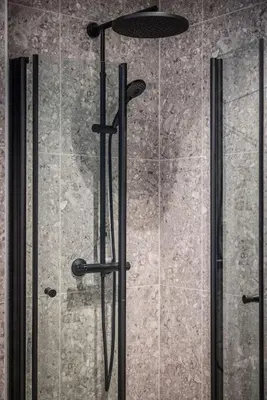 a glass shower door with four black handles at Stay l Luxurious Hideaway in Centrum in Bergen
