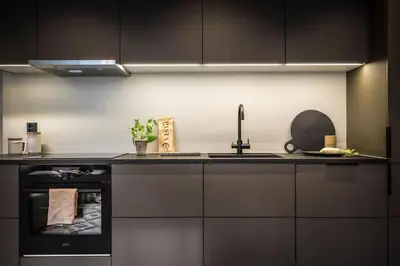 a kitchen with a sink and a stove at Stay l Luxurious Hideaway in Centrum in Bergen