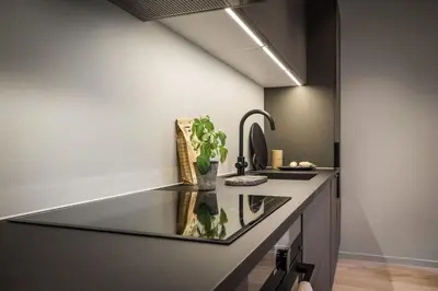 a kitchen with a glass counter top and a sink at Stay l Luxurious Hideaway in Centrum in Bergen