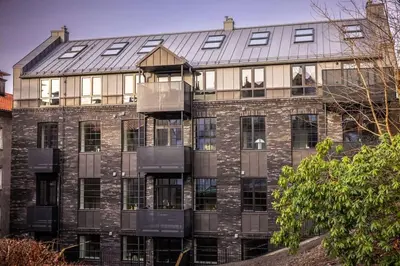 a large brick building with a lot of windows at Stay l Luxurious Hideaway in Centrum in Bergen