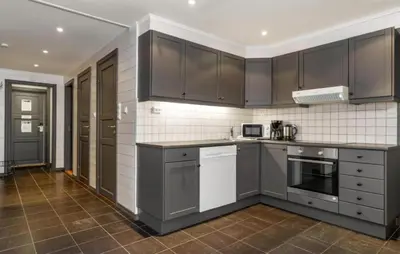 a kitchen with stainless steel appliances and brown cabinets at Awesome Apartment In Hemsedal With Wifi in Hemsedal