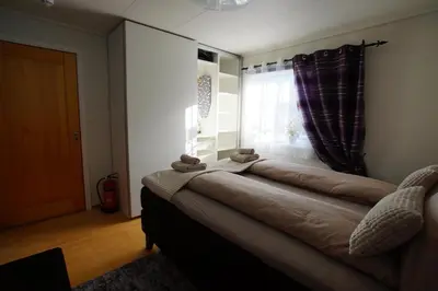 a room with a bed with two teddy bears on it at Cozy room in a house with a garden on the island of Askøy, near Bergen in Askøy