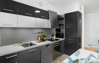 a kitchen with gray cabinets and a sink and a counter at Nydelig leilighet på Nordnes! in Bergen