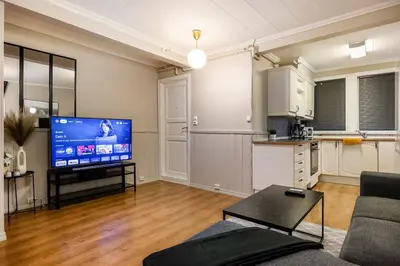 a living room with a couch and a flat screen tv at Central stay apartment - 302 in Bergen
