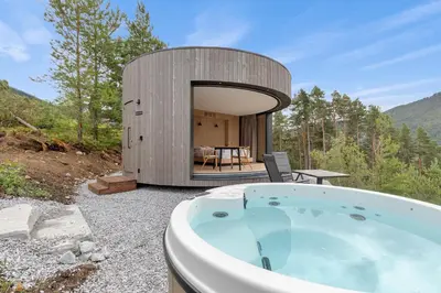 a circular building with a jacuzzi tub in the woods at Sogndal Fjordpanorama- The Panorama View 2 in Sogndal