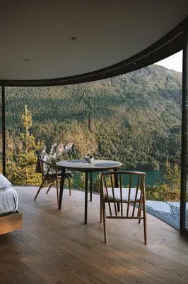 a table and chairs in a room with a view at Sogndal Fjordpanorama- The Panorama View 2 in Sogndal