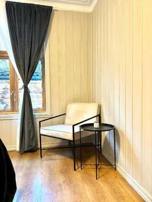 a room with a chair and a table and a window at Central stay apartment - 303 in Bergen