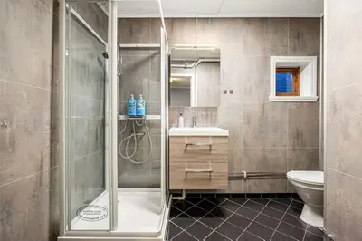 a bathroom with a shower and a sink and a toilet at Central stay apartment - 303 in Bergen