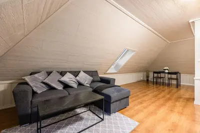 a living room with a couch in a attic at Central stay apartment - 401 in Bergen